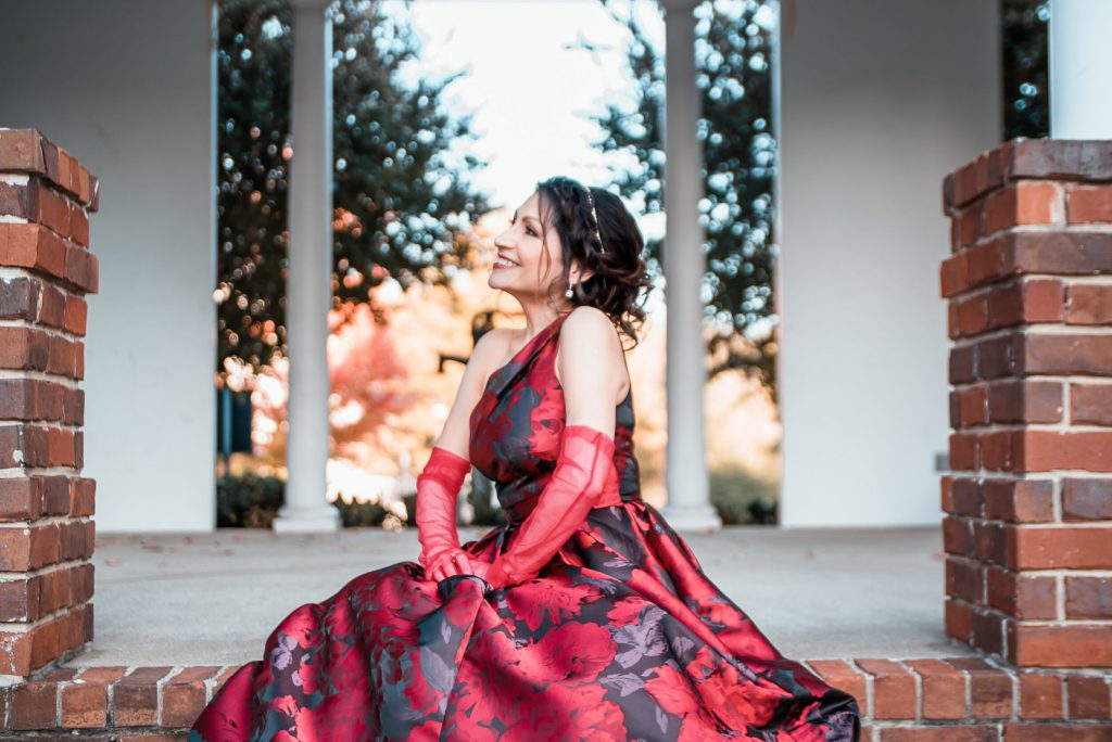 Monica Ortiz smiling in red dress