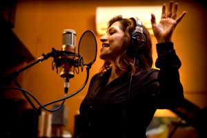 Monica singing in the recording booth